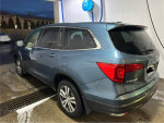 2017 Honda Pilot EX-L in blue, parked at a car wash, showcasing its sleek design and clean exterior.