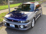 2001 Subaru Impreza with new features, parked on the street, showcasing its modified exterior and quality performance.