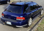 2001 Subaru Impreza, blue color, parked on the street with a clean exterior and aftermarket wheels.