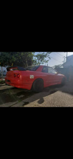 1989 Nissan Skyline GTS-T Type M in great condition with aftermarket parts, parked in a garage.