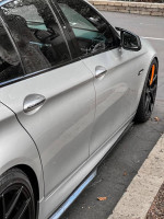 Side view of a silver 2011 BMW 5 Series 528i with M5 exterior kit and black wheels