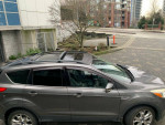 2013 Ford Escape SEL in Sterling Gray Metallic parked, showcasing its sleek design and roof rails.