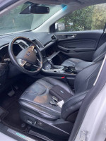 Interior view of a well-maintained 2016 Ford Edge Titanium with leather seating and modern controls.