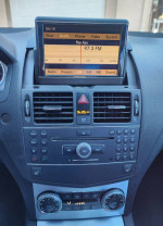 Interior view of a 2008 Mercedes-Benz C300, featuring a luxury sound system and climate controls.