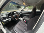 Interior view of a 2011 Subaru Outback 2.5i AWD showing stylish seats and dashboard features.