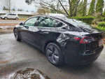 2018 Tesla Model 3 Mid Range RWD parked in great shape with new tires and a clean title.