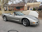 2001 Chevrolet C5 Corvette Convertible in Pewter Metallic parked on the street with garage in background