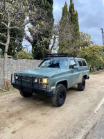 1984 Chevrolet K5 Blazer with small block 350 engine parked on a dirt road, showcasing its rugged design.