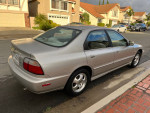 1997 Honda Accord Special Edition in silver, parked on the street, showcasing excellent condition and low mileage.