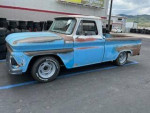 1965 Chevy shortbed pickup truck with vintage patina, 350 engine, and Dakota gauges, parked on a lot.