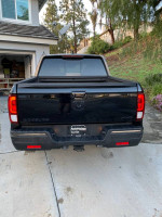 Rear view of a 2017 Honda Ridgeline Black Edition AWD parked in a driveway
