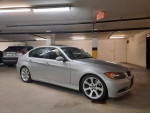2006 BMW 330i parked in an underground garage, featuring sport and luxury packages, well-maintained with recent services.