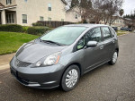 2013 Honda Fit in grey with 69,000 miles parked on a street, featuring a clean exterior and interior.