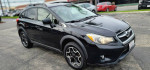 2014 Subaru Crosstrek AWD in black, featuring a clean exterior and new tires, parked outdoors.