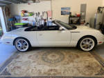 2003 Thunderbird hardtop convertible in a clean garage with new tires, stylish rims, and a well-maintained interior