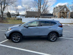2021 Honda CRV EX in gray color parked, featuring all wheel drive and modern design.