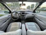 Interior view of a 2001 Toyota Prius showing clean seats and dashboard.