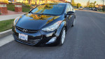 2013 Hyundai Elantra Limited in black with 124,000 miles, parked on a residential street