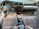 Interior view of 2004 Subaru Legacy showing dashboard and seats, 129,000 miles, well-maintained car.