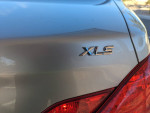 Close-up of Toyota Avalon XLS badge on the sleek silver rear of the car
