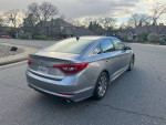 2015 Hyundai Sonata silver sedan parked on street, excellent condition, 128,000 miles with newer tires and brakes.