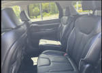 Interior view of a 2023 Hyundai Palisade featuring premium black leather seats and ample space.
