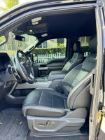 Interior view of 2020 Ford F-150 Raptor showing leather seats and modern dashboard.