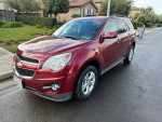 2010 Chevrolet Equinox in red, showcasing clean design and features like alloy wheels and rear view camera.