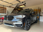 2019 BMW X3 parked in garage, featuring M wheel package and panoramic moon roof, with 47k miles.