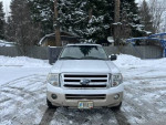 2009 Ford Expedition Eddie Bauer in snow, reliable family vehicle with spacious seating and two tire sets.