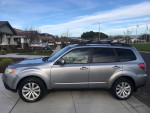 2011 Subaru Forester limited edition AWD parked on a residential street, showcasing its sleek design and winter package features