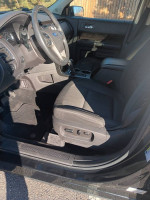 Interior view of a 2013 Ford Escape SEL showing black fabric seats and dashboard features.