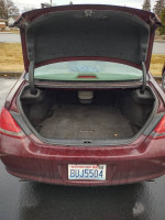 Open trunk of a 2008 Toyota Avalon showcasing spacious interior with clean carpet and trunk space
