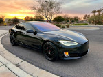 2018 Tesla Model S P100D in black, parked with sunset in the background, showcasing premium features and design.