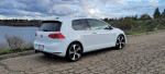 2015 Volkswagen GTI parked near a lake, showcasing clean title and great condition, ready for a new owner.