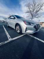 2019 Hyundai Elantra SEL in silver parked, showcasing its sleek design and modern features.