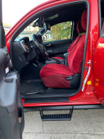 Interior view of a 2019 Toyota Tacoma TRD Off Road 4WD featuring red seats and a modern dashboard.