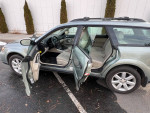 2009 Subaru Outback interior with open doors, showcasing 5-speed manual transmission and clean seating.