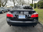 2009 Hyundai Genesis sedan in original condition with polished alloy wheels and tinted windows.
