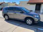 2014 Honda CR-V LX FWD parked on the street, showcasing its clean exterior and design.