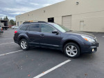 2013 Subaru Outback 2.5L Premium with all-wheel drive parked in a lot, highlighting its clean title and family-friendly features.