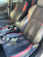 Interior view of a 2016 Subaru WRX STI showing sporty black and red seats.