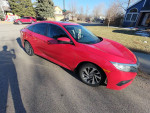 2016 Honda Civic EX in Rallye Red parked on a residential street with sunlight