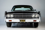 Front view of a restored 1963 Lincoln Sedan in pristine condition with California license plate.
