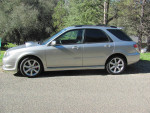 2006 Subaru WRX wagon in silver, parked outdoors with a scenic background, showcasing its sporty design.