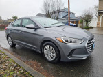 2017 Hyundai Elantra, gray sedan, clean title, 126,000 miles, parked on a rainy street