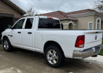 White Dodge Ram 1500 4x4 with 5.7 Hemi engine parked in excellent condition.