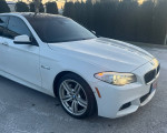 2011 BMW 535xi M-sport Sedan in alpine white with black leather interior and sporty design.