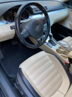 Interior view of a 2012 Volkswagen CC with beige and black dual-tone seating and modern dashboard design.