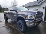 2014 Ram 2500 Laramie 4WD truck with oversized tires, clean title, and crew cab in front view.